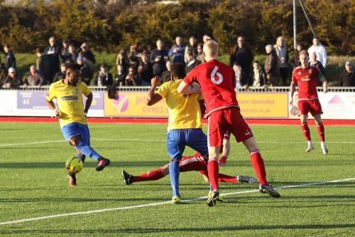 Enfields Bobby Devyne (L) sees his shot blocked by Gary Elphick