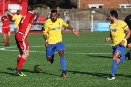 Enfields Bobby Devyne (yellow, L) runs at Matt Boiling with Tyler Campbell offering support