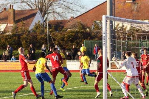 Enfields Karl Oliyide (yellow, centre) sends a header against the post