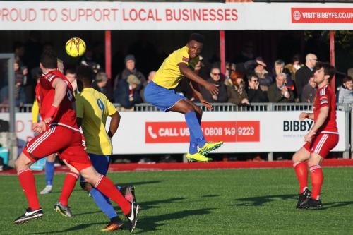 Enfields Karl Oliyide heads the ball forward941