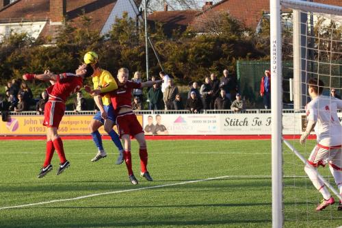 Enfields Mickey Parcell (yellow) gets a header on target producing a save from Kieron Thorp