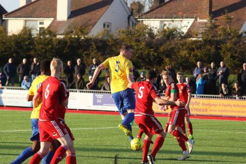 Mark Kirby (yellow 5) misses his header but the ball runs for Karl Oliyide (behind no 6, Corey Heath) for the third Enfield goal