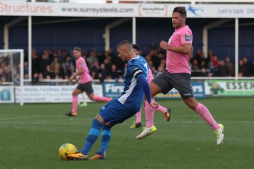 Billericays Paul Konchesky clears from Adam Martin