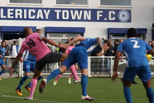 Billericays Rob Swaine (blue) heads clear from Simon Thomas