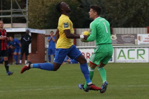 Brightlingsea keeper Sam Cowler beats Ryan Blake to the ball