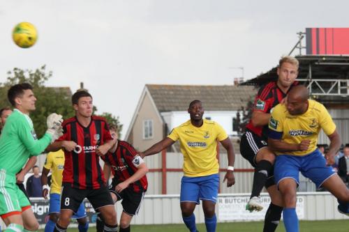 Brightlingsea keeper Sam Cowler is well beaten by Simon Thomass header but the ball hits the post