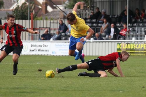 Brightlingseas Connor Witherspoon (R) tackles Sam Youngs as James Love covers