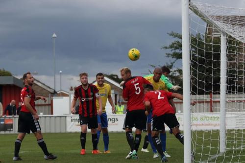 Brightlingseas Ricky Griggs (2) heads off the line, although the referee gave a foul against Enfield