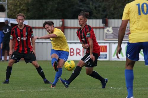 Enfields Mario Noto shoots as Ricky Griggs tries to block