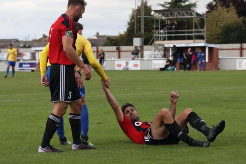 Enfields Mickey Parcell helps Aaron Condon to his feet