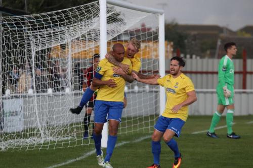 Enfields Ryan Blackman (rear) and Drew Roberts (R) congratulate scorer Simon Thomas