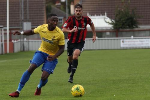 Enfields Ryan Blake (yellow) and Brightlingseas Aaron Condon