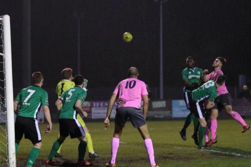 Enfields Dan Rumens (pink, R) heads over the bar
