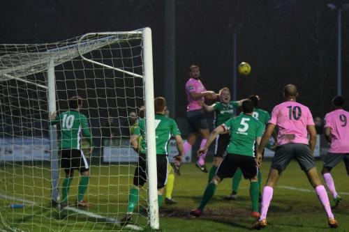 Enfields Mat Mitchel-King (pink, L) heads the ball across the box