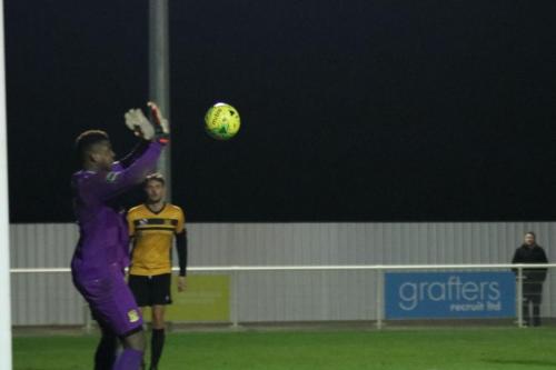 Cheshunt keeper Montel Joseph saves Simon Thomass header