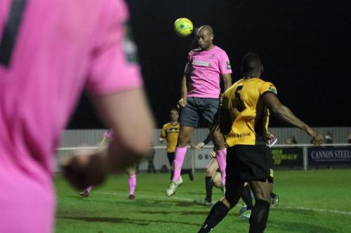 Enfields Simon Thomas (pink) heads on goal