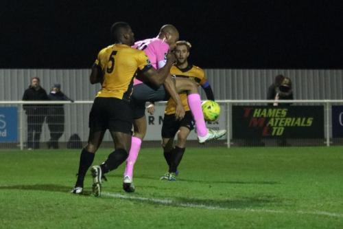 Enfields Simon Thomas (pink) holds off John Osonowa