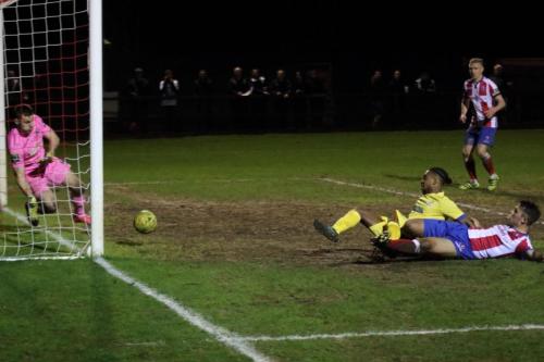 After the ball had rebounded off the far post, Dorking keeper Slavomir Huk gets across to block Dernell Wynters follow up