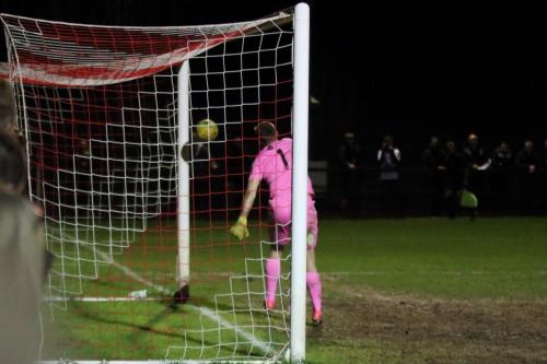 Dorking keeper Slavomir Huk can only look on as a cross rebounds off the far post