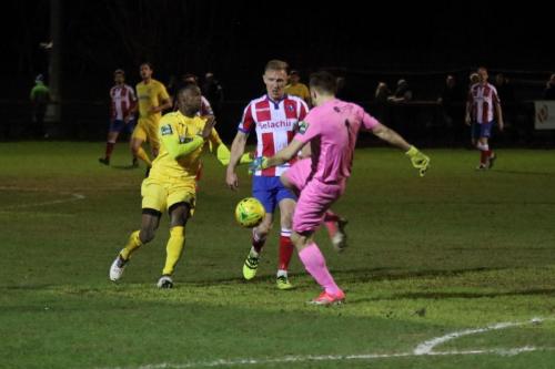 Dorking keeper Slavomir Huk clears from Ryan Blake