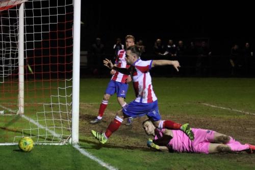 Dorking keeper Slavomir Huk is beaten but the shot rolls just wide