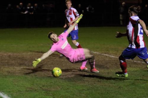 Dorking keeper Slavomir Huk is beaten but the shot rolls just wide14