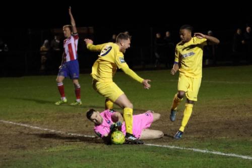 Enfields Brad Wadkins (L) and Dernell Wynter challenge Slavomir Huk