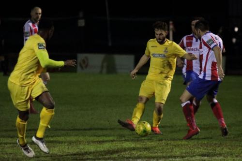 Enfields Jack Hockney (yellow, R) challenged by Dean Hamlin