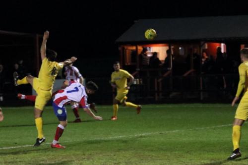 Enfields Mario Noto (L) challenges Anthony Oakes