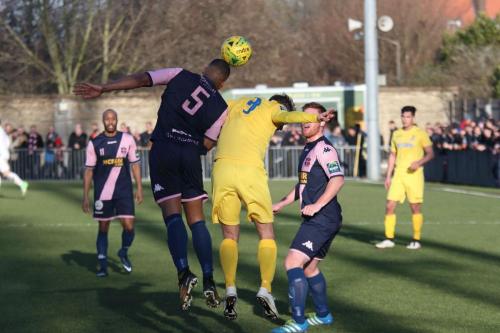 Dulwichs Rickie Hayles (5) heads clear from Liam Hope