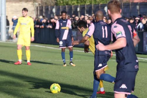 Enfields Tyler Campbell (yellow) challenged by Sanchez Mings