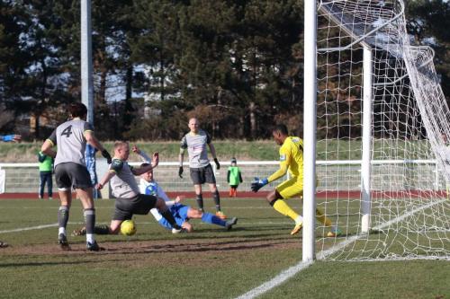 Enfields Liam Hope (white) just fails to reach a cross from the left wing