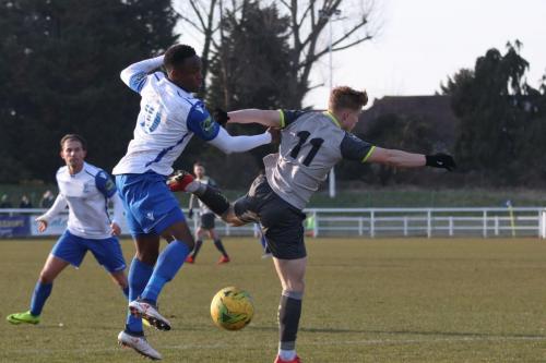 Enfields Ryan Blake challenges Nathan Wood (R)