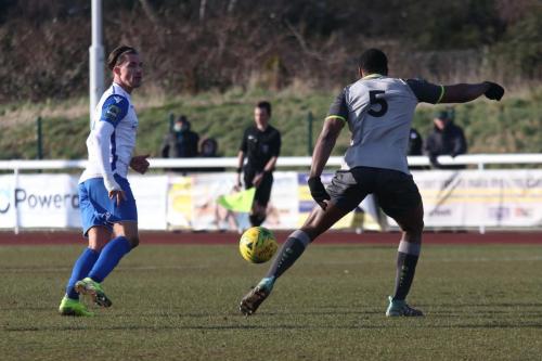 Enfields Sam Youngs (L) plays the ball past Jerry Nnamani