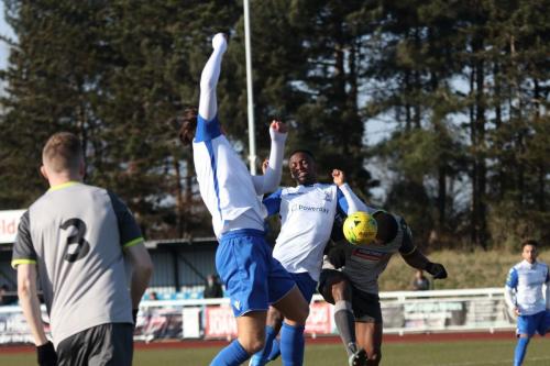 Enfields Sam Youngs (white, L) and Ryan Blake challenge for a cross with Jerry Nnamani