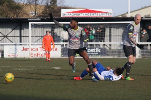 Enfields Tyler Campbell collides with DSean Theobalds (L) who indicates that there wasnt a foul, and the referee agrees
