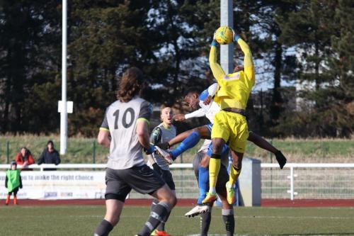 Leatherhead keeepr Manny Agboola catches an awkward ball under pressure from Ryan Blake