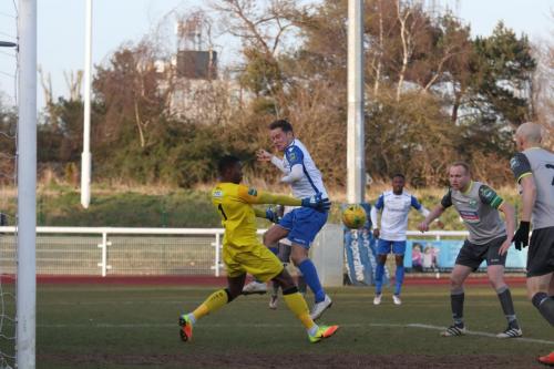 Leatherhead keeepr Manny Agboola knocks the ball away from Liam Hope