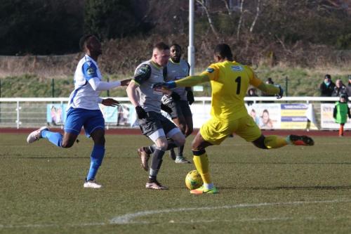 Leatherhead keeper Manny Agboola clears from Ryan Blake