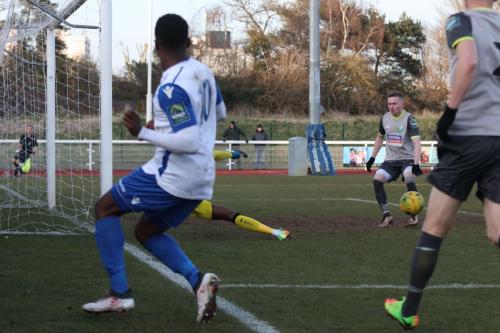 Leatherhead keeper Manny Agboola sticks out a leg to divert Ryan Blakes cross to safety