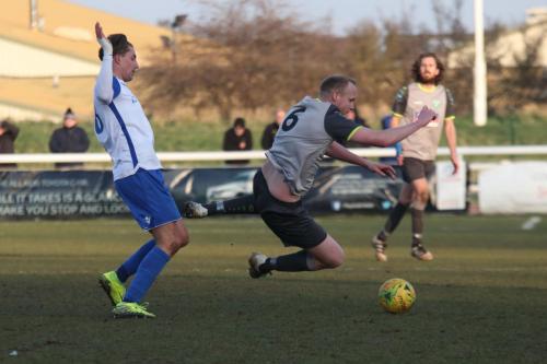 Leatherheads Lee Minshull (R) is clipped by Sam Youngs