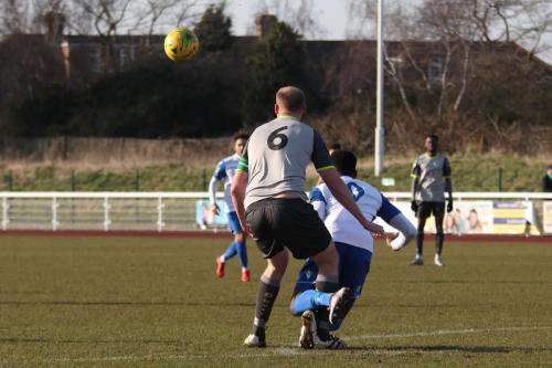 Leatherheads Lee Mishull (L) brings Ryan Blake down on the edge of the penalty area