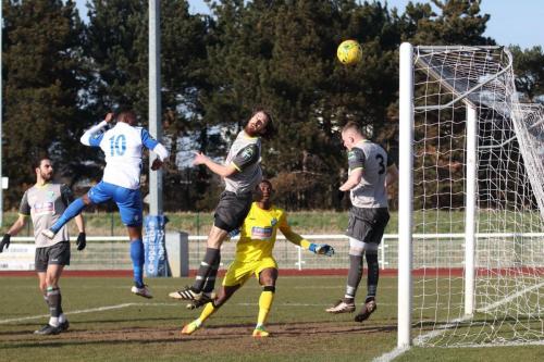 With keeper Manny Agboola beaten, Leatherheads Jack Midson (grey, centre) heads the ball clear for a corner