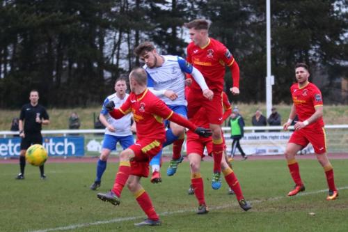 Enfields Dan Rumens challenged by Adam Mills (red, L) and Jake Dye
