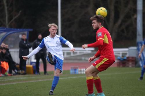 Enfields Ryan Blackman (L) lifts the ball over Callum Sturgess