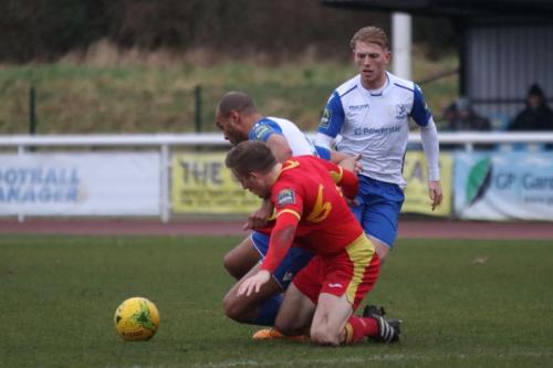 Enfields Simon Thomas (white, L) tussles with Dan Morphew as Ryan Blackman looks on