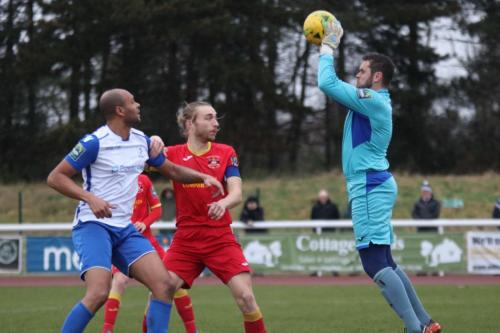 Needham keeper Danny Gay collects the ball ahead of Simon Thomas (L) and Keiran Morphew