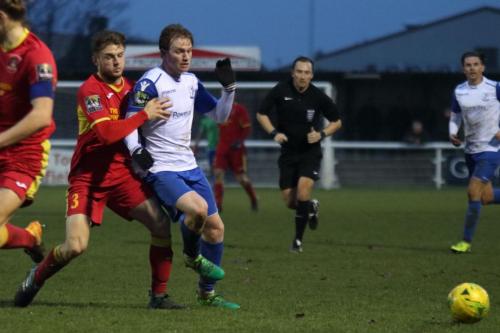 Needhams Callum Sturgess (red) and Enfields Aaron Greene