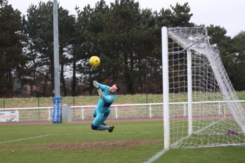 Needhams Danny Gay pushes Mario Notos free kick round the post