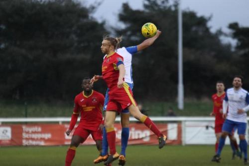Needhams Keiran Morphew (red) challenges Simon Thomas
